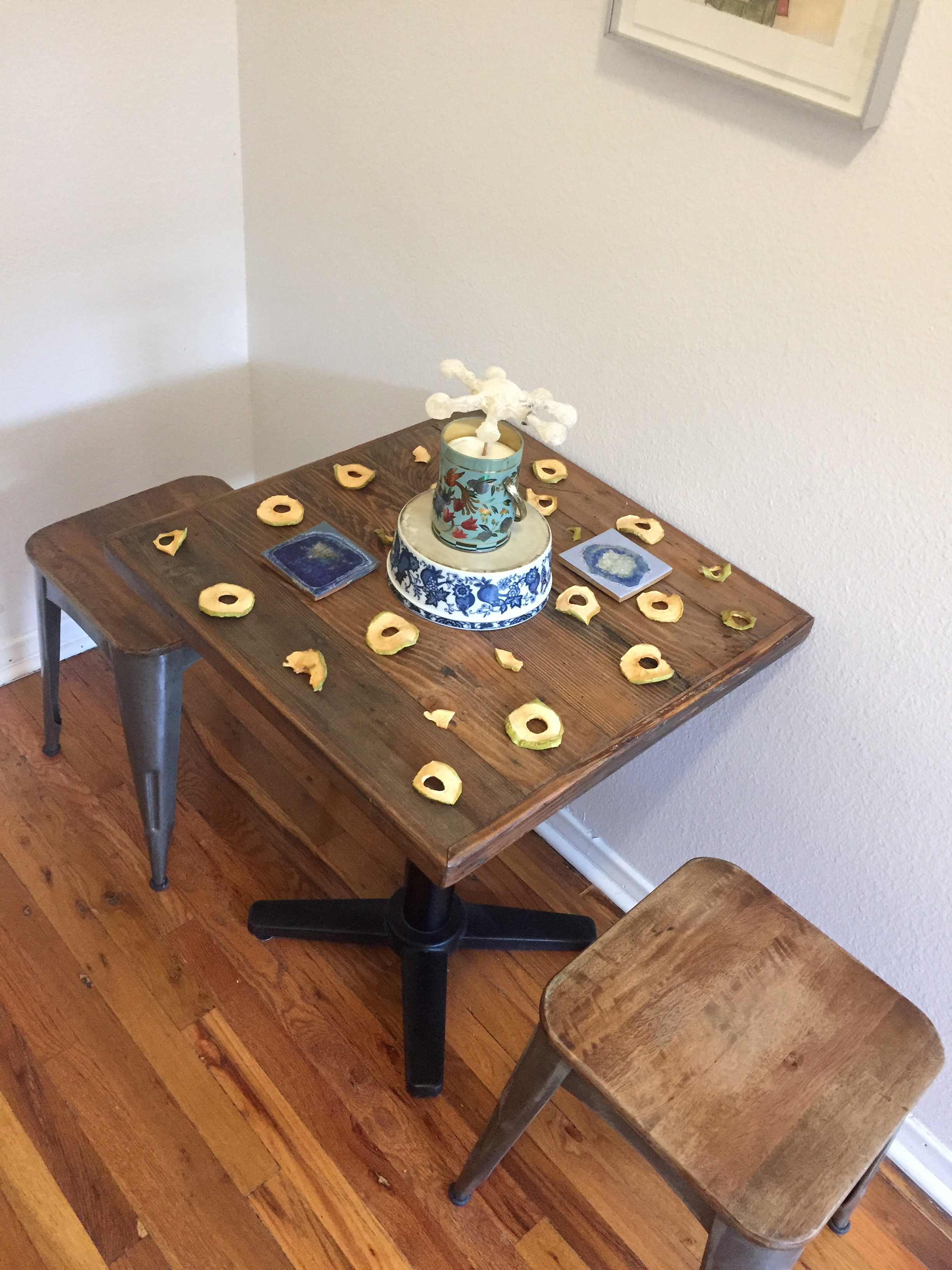 A sugar sculpture in an asterisk shape surrounded by dried apple peels on a table